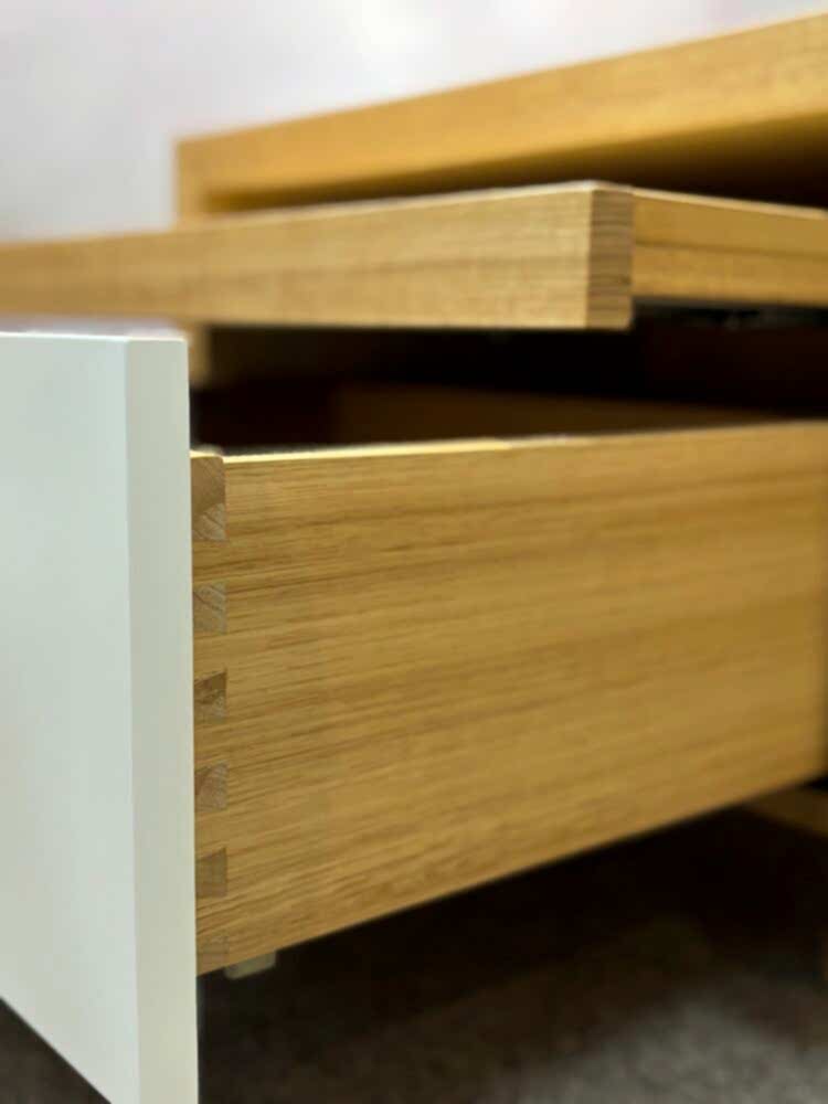 Adelaide, South Australian made oak timber bedside table with drawer and hidden shelf. Side view of drawer