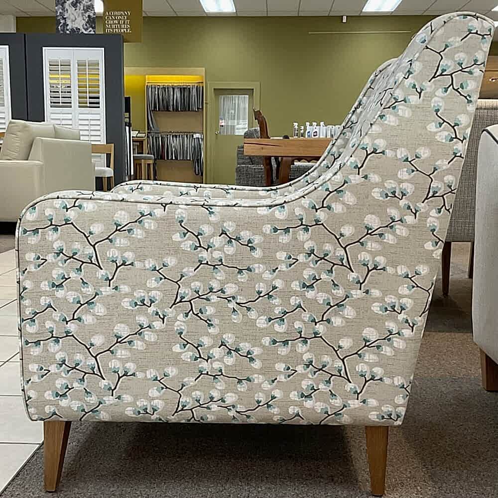 Molmic, Melbourne made fully pattern upholstered occasional chair with timber legs. View of side