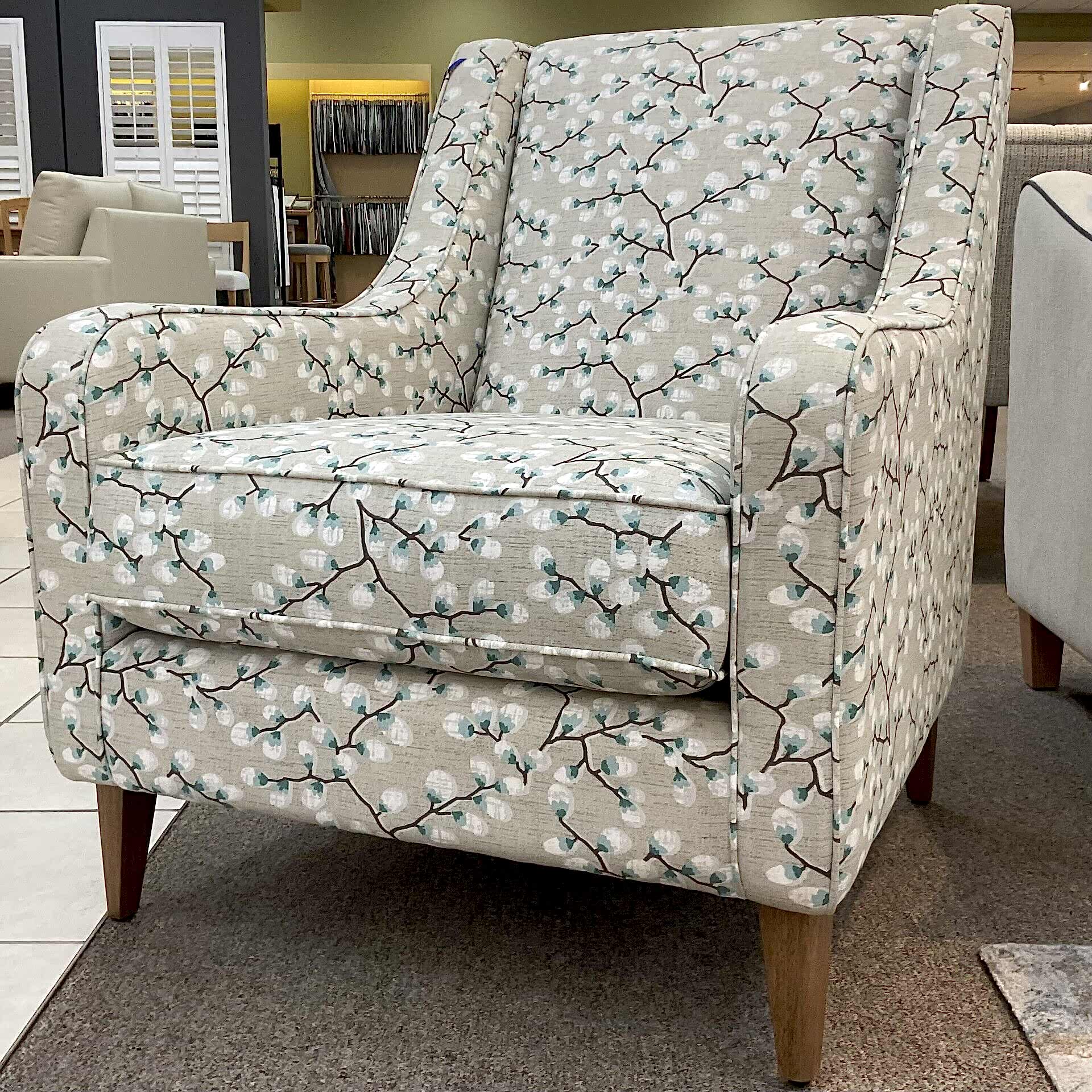 Molmic, Melbourne made fully pattern upholstered occasional chair with timber legs. View of side angle