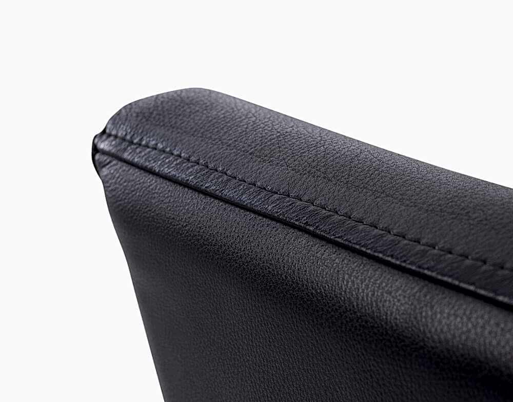 Adelaide, South Australian made solid timber Leone Low Back premium dining chair upholstered in black leather, view of top detail.