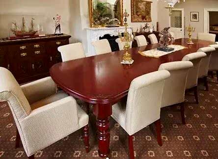 classic mahogany large dining table with white upholstered chairs